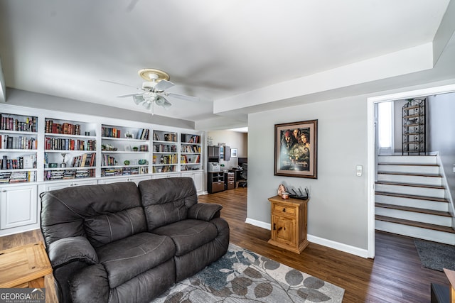 living room featuring dark hardwood / wood-style flooring and ceiling fan