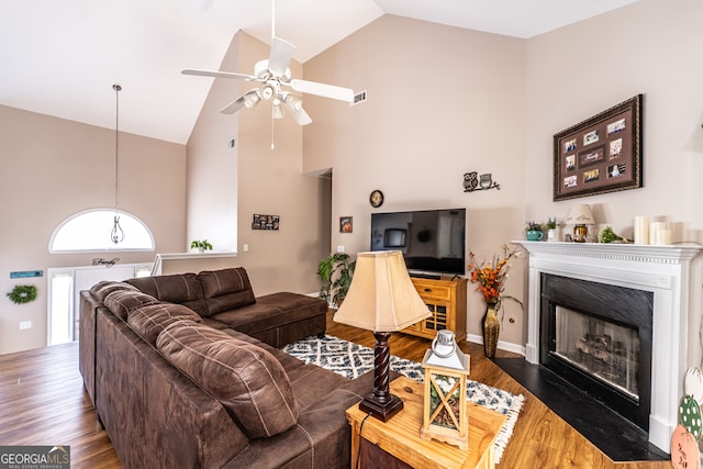 living room with high vaulted ceiling, ceiling fan, and dark hardwood / wood-style floors