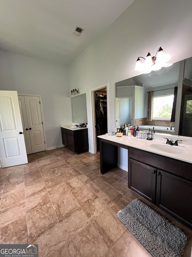 bathroom with vanity and vaulted ceiling