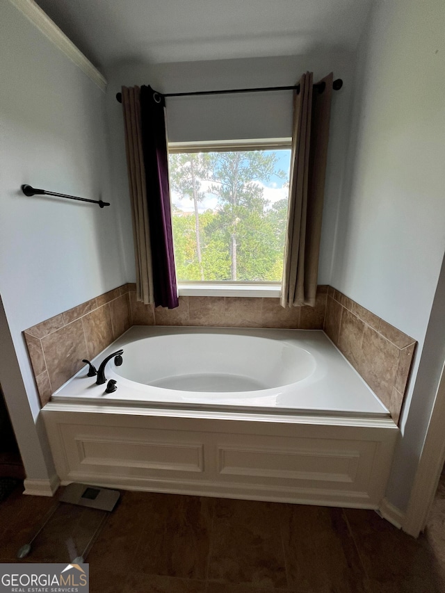 bathroom with a bathtub and tile patterned floors