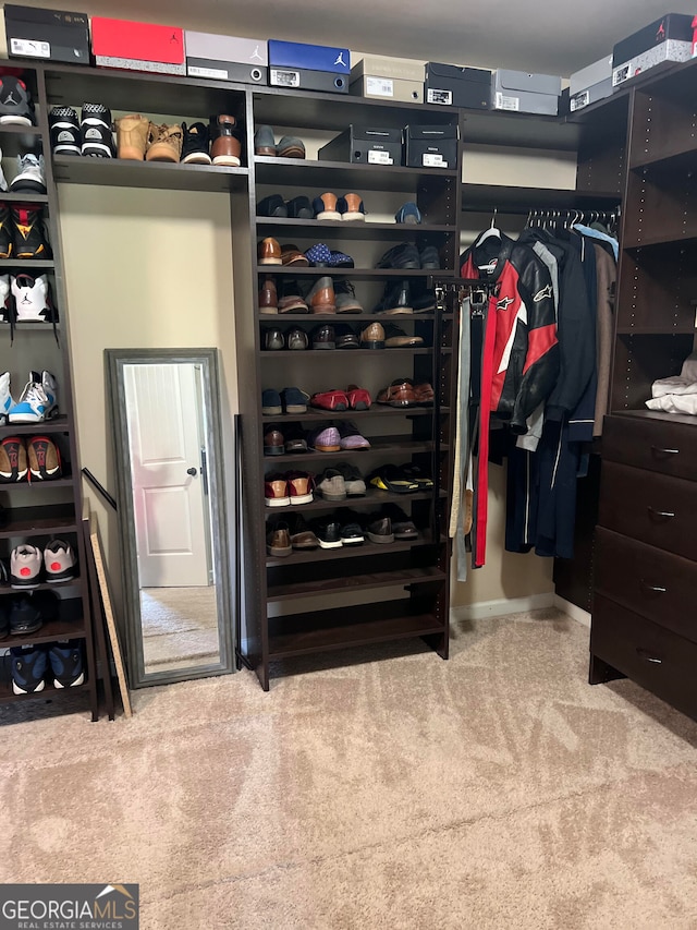 walk in closet featuring carpet