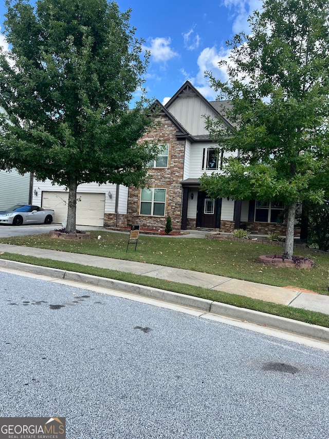 view of front facade featuring a front yard and a garage