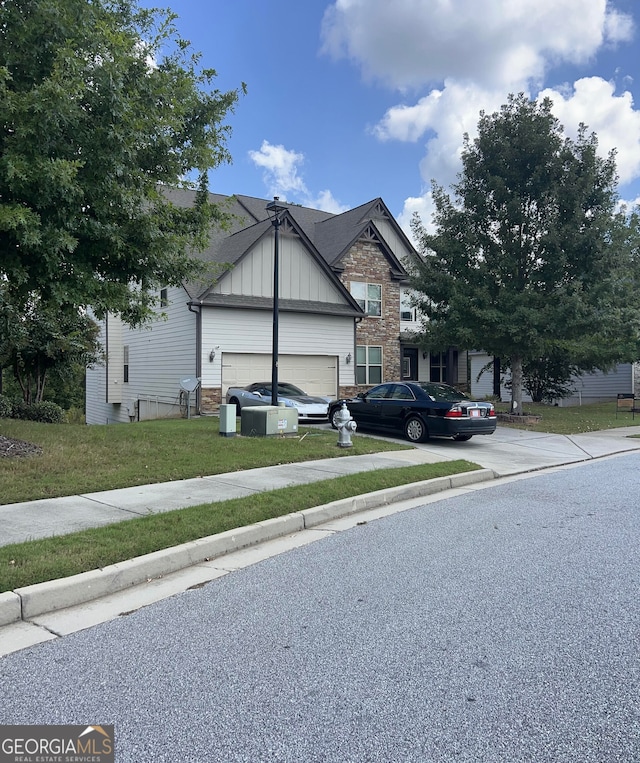 view of front of home with a front yard and a garage