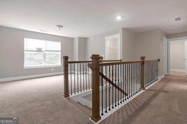 hallway featuring light carpet