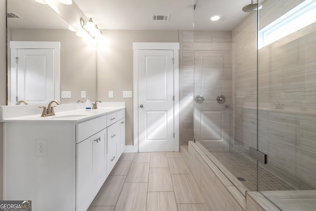 bathroom featuring vanity and a shower with shower door