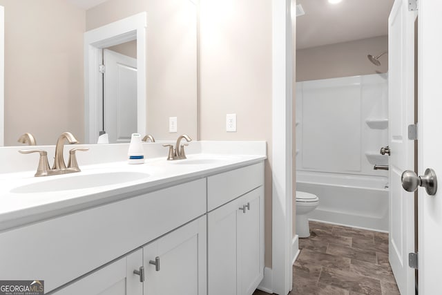 full bathroom with vanity, bathtub / shower combination, and toilet