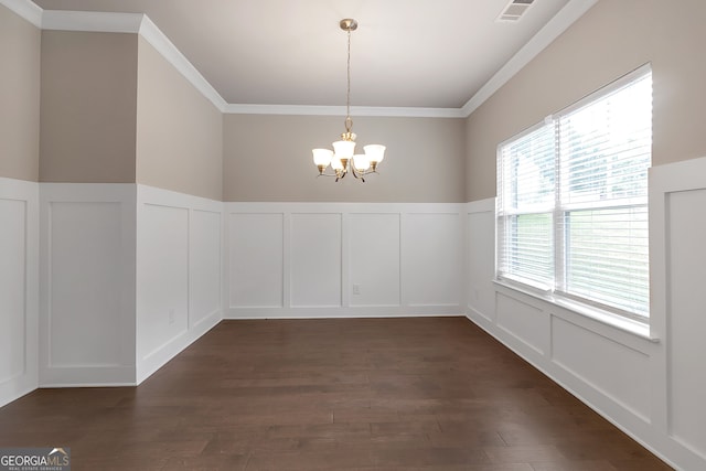 unfurnished dining area featuring ornamental molding, an inviting chandelier, and dark wood-type flooring