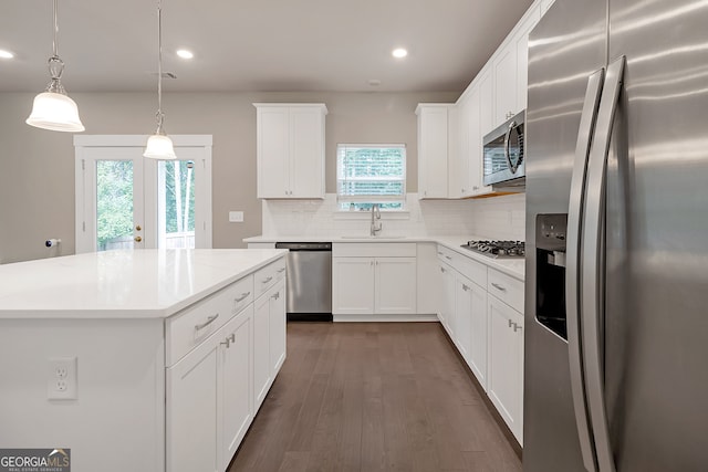 kitchen featuring white cabinetry, stainless steel appliances, and a wealth of natural light