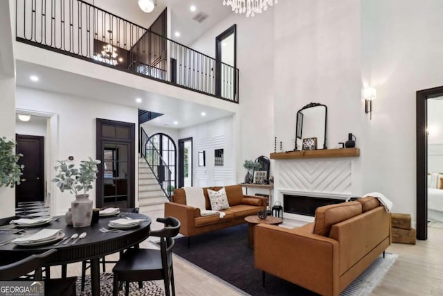 living room featuring a high ceiling and light hardwood / wood-style flooring