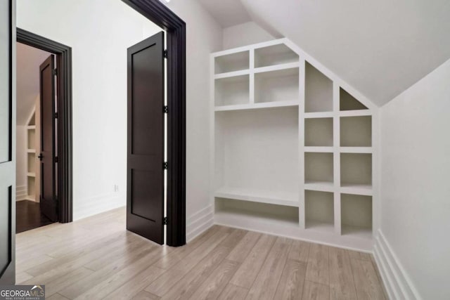 interior space featuring vaulted ceiling and light wood-type flooring