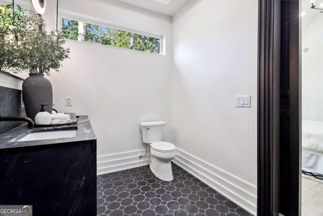 bathroom featuring vanity and toilet