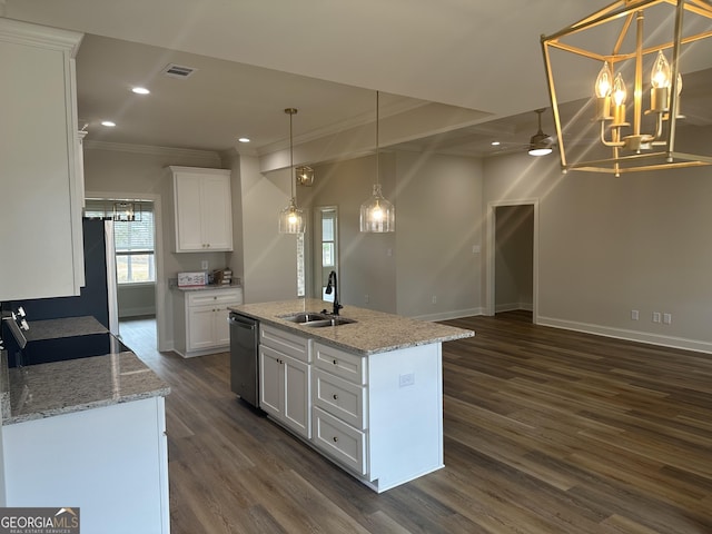 kitchen with sink, white cabinets, an island with sink, and decorative light fixtures