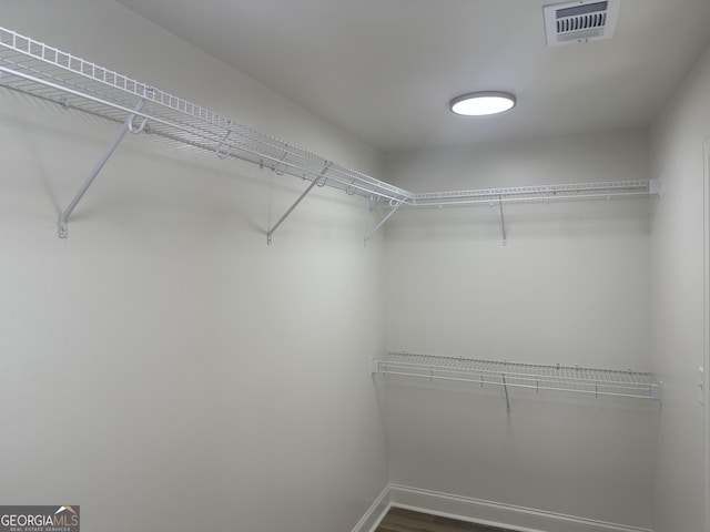 spacious closet featuring hardwood / wood-style flooring