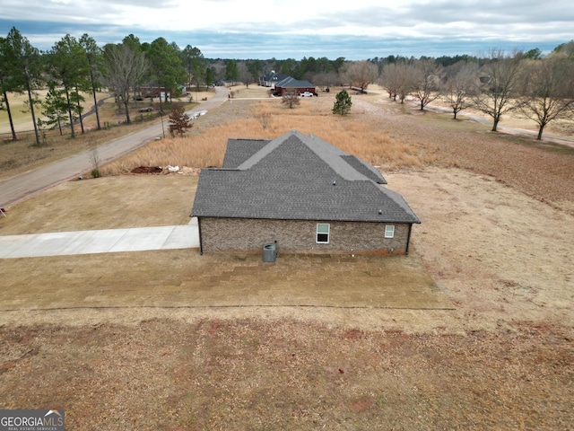 birds eye view of property with a rural view