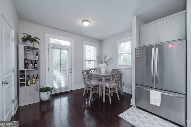 dining space with dark hardwood / wood-style floors