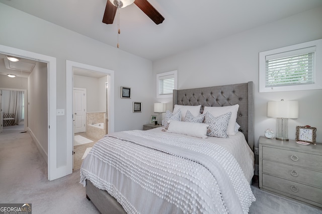 bedroom featuring ensuite bath, ceiling fan, and light colored carpet