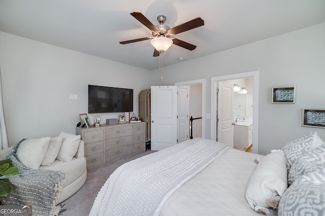 bedroom with light carpet, ensuite bathroom, and ceiling fan