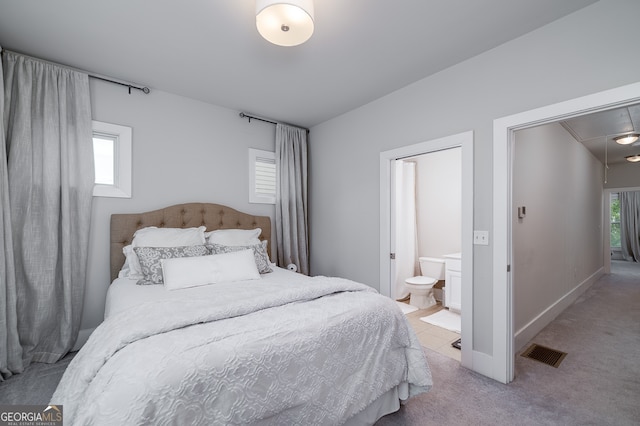 carpeted bedroom featuring a closet and connected bathroom