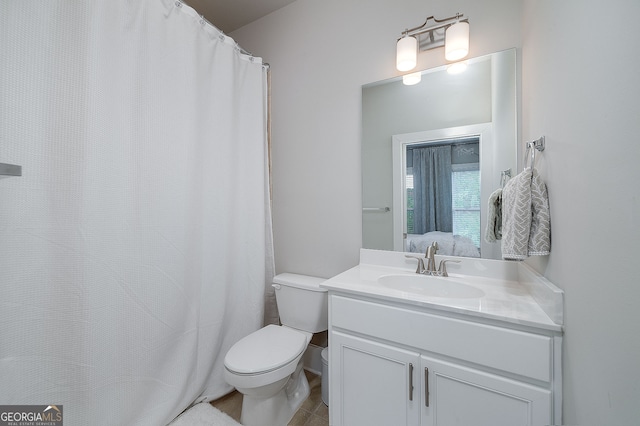 bathroom with tile patterned floors, vanity, and toilet