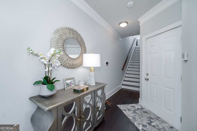 foyer entrance featuring ornamental molding and dark hardwood / wood-style flooring