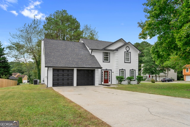 view of front of property with a front lawn, central AC unit, and a garage