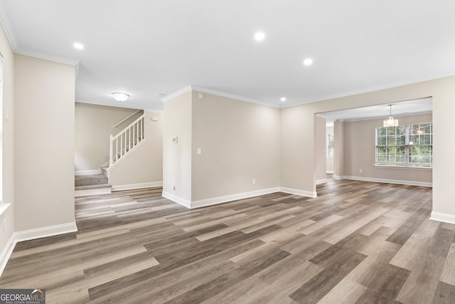 unfurnished room with hardwood / wood-style flooring and crown molding