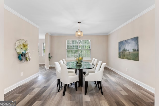 dining room with hardwood / wood-style flooring and ornamental molding