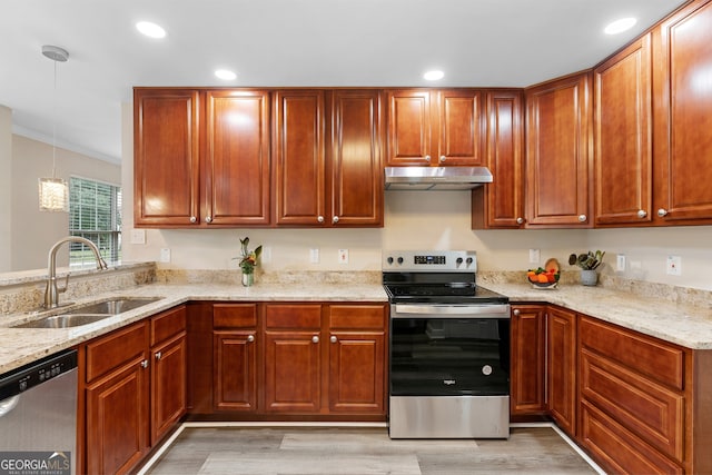 kitchen with light hardwood / wood-style floors, sink, pendant lighting, and stainless steel appliances