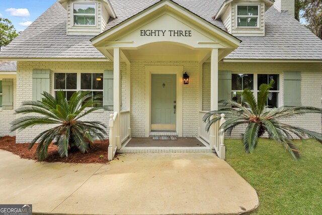 view of front of home featuring covered porch and a front yard