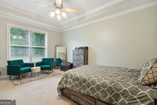 bedroom with ceiling fan, a raised ceiling, crown molding, and carpet flooring