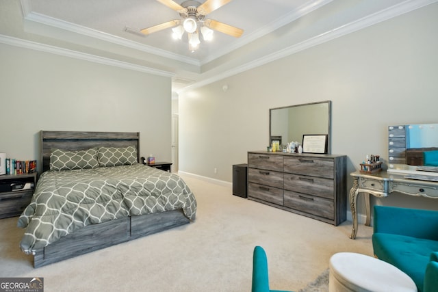 bedroom featuring ceiling fan, light colored carpet, a tray ceiling, and crown molding