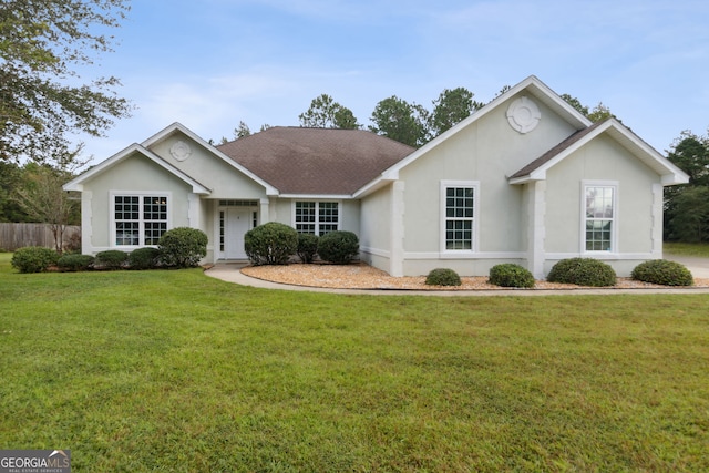 single story home featuring a front lawn