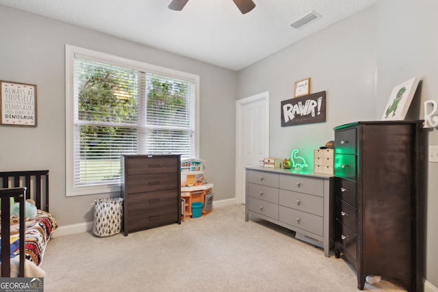 carpeted bedroom with multiple windows and ceiling fan