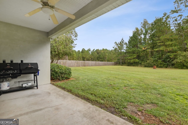 view of yard featuring ceiling fan and a patio area