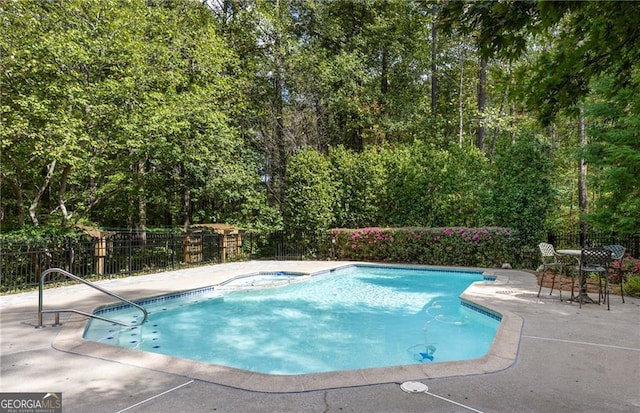 view of swimming pool featuring a patio area