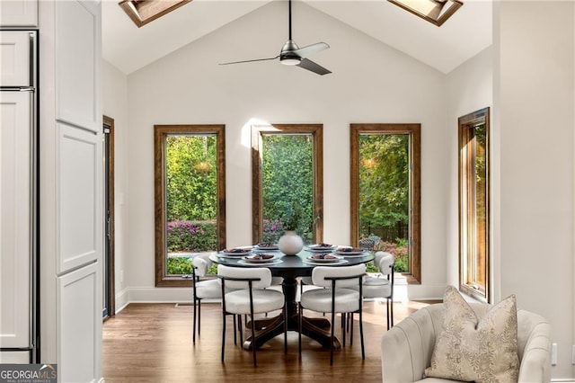 sunroom / solarium featuring ceiling fan and vaulted ceiling with skylight