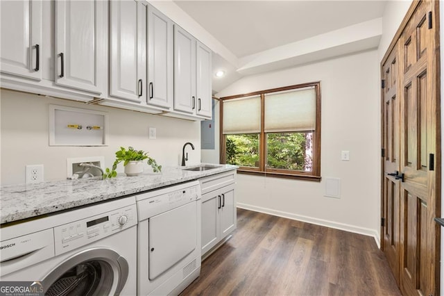 washroom with cabinets, sink, dark hardwood / wood-style flooring, and independent washer and dryer