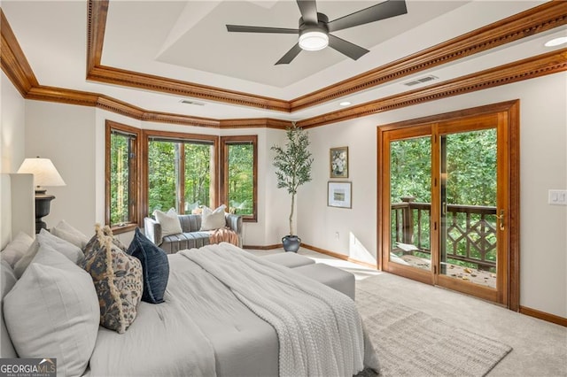 carpeted bedroom featuring access to outside, a tray ceiling, crown molding, and ceiling fan