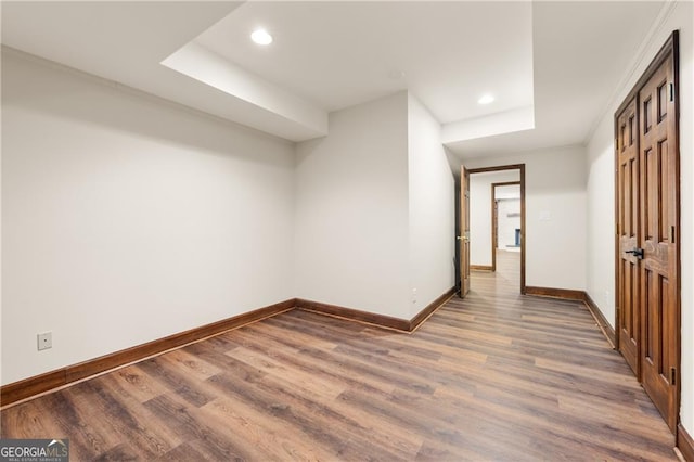 additional living space with hardwood / wood-style floors