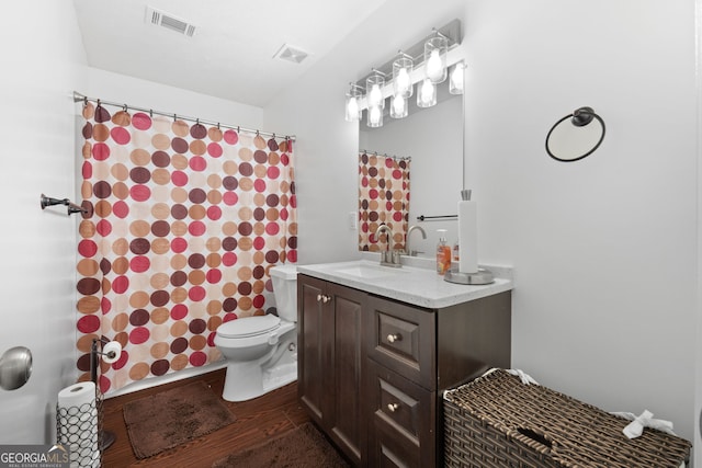 bathroom featuring wood-type flooring, a shower with curtain, vanity, and toilet