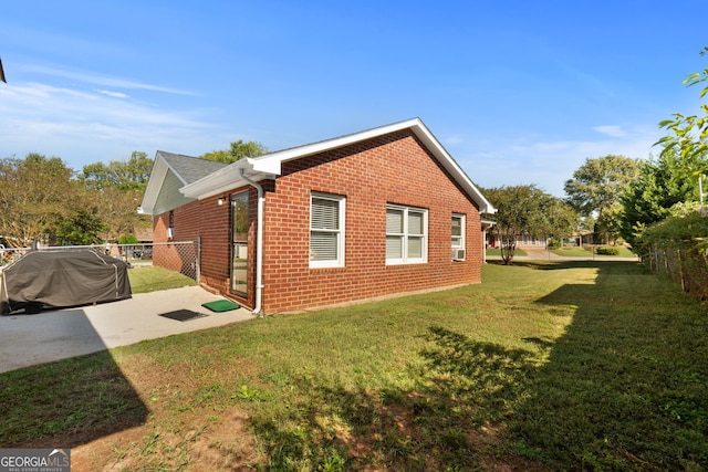 view of property exterior featuring a lawn and a patio area