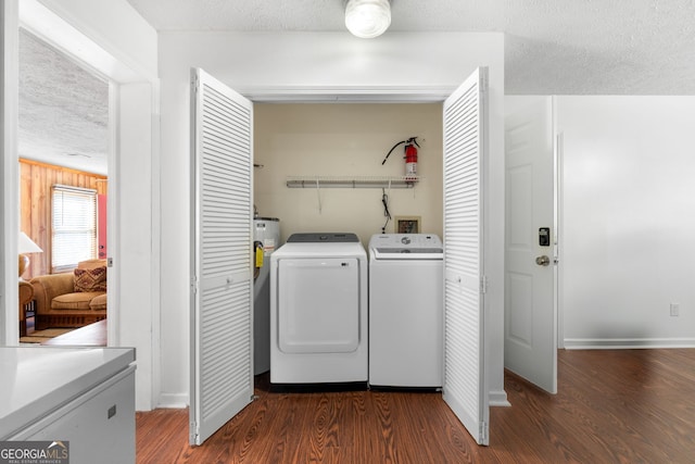 laundry room with a textured ceiling, dark hardwood / wood-style floors, and independent washer and dryer