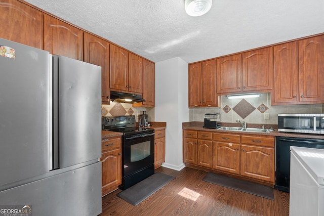 kitchen featuring sink, stainless steel appliances, backsplash, and dark hardwood / wood-style floors