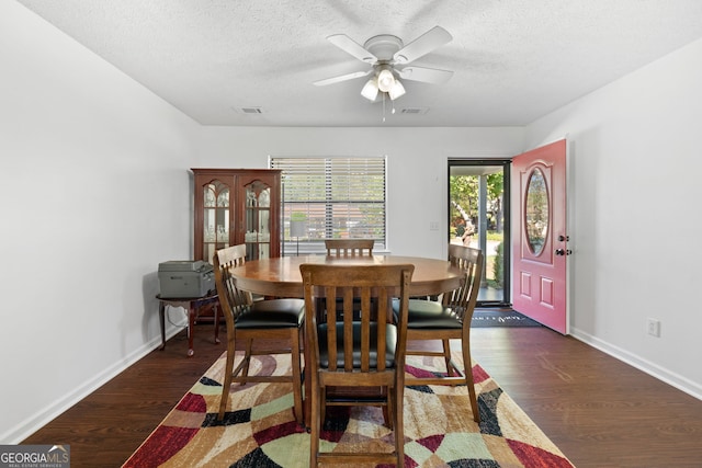 dining area with a textured ceiling, dark hardwood / wood-style floors, and ceiling fan