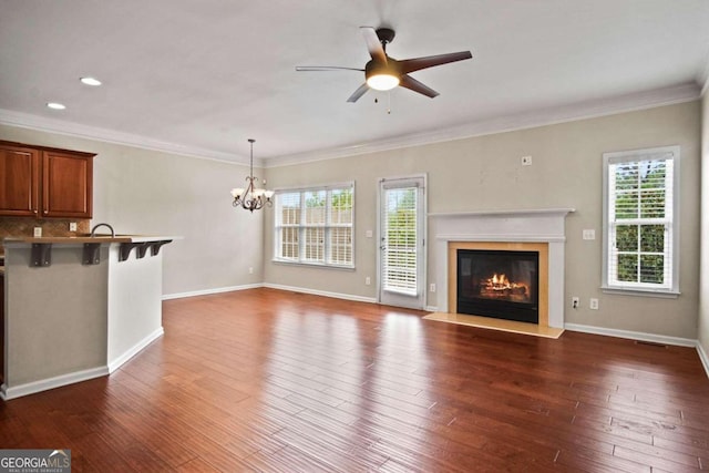 unfurnished living room featuring ceiling fan with notable chandelier, sink, dark hardwood / wood-style floors, and crown molding