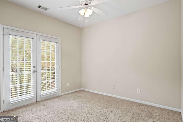 spare room with carpet floors and ceiling fan