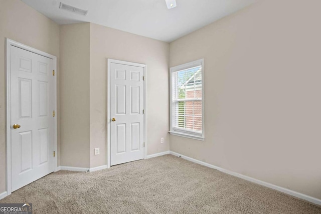 unfurnished bedroom with carpet flooring