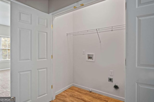 clothes washing area featuring light wood-type flooring, hookup for a gas dryer, washer hookup, and electric dryer hookup