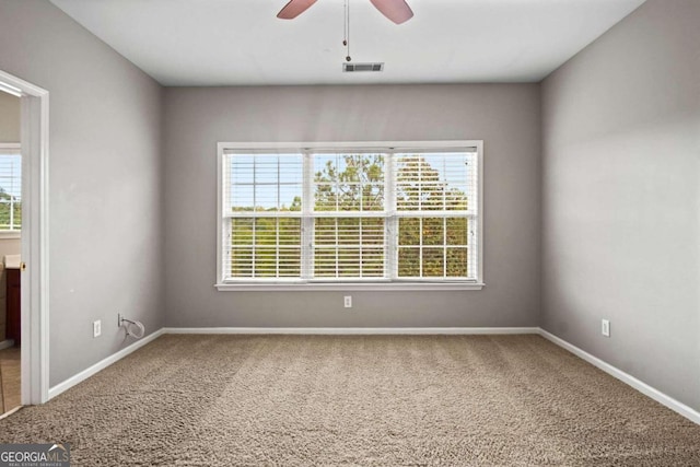 spare room featuring ceiling fan and carpet flooring