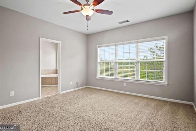 spare room featuring carpet floors and ceiling fan